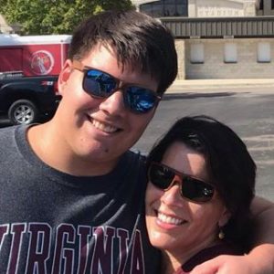 A college kid and his mom hugging goodbye