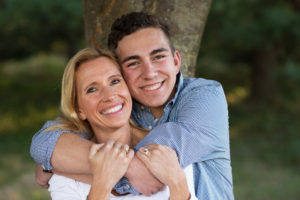 A college kid and his mom hugging goodbye